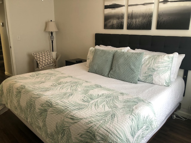 bedroom featuring dark wood finished floors