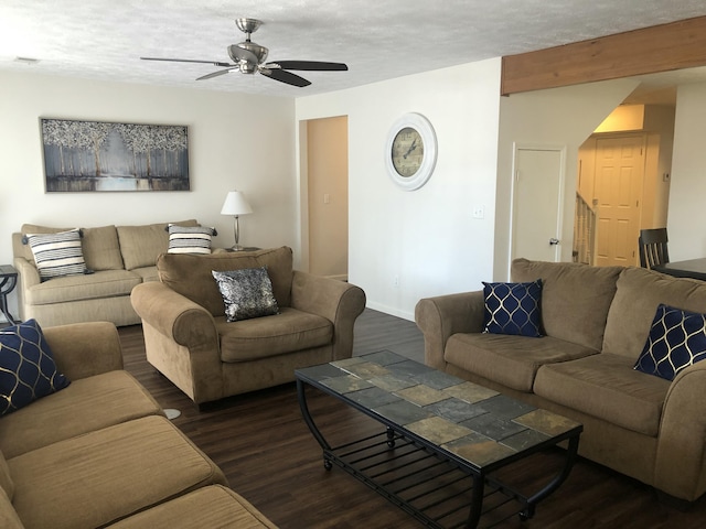 living room with dark wood-style floors, a textured ceiling, and a ceiling fan