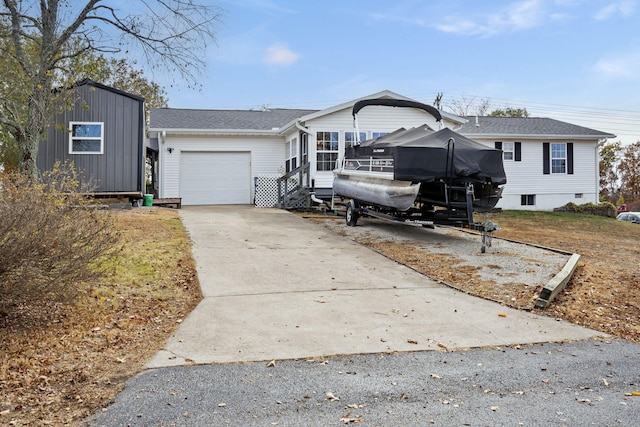 view of front of home featuring driveway, an attached garage, and a shingled roof