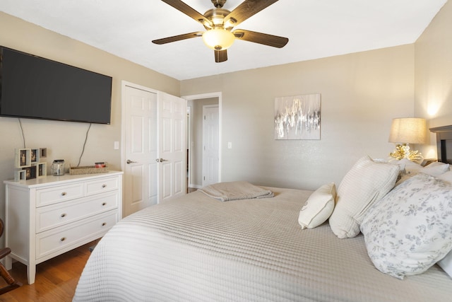 bedroom featuring ceiling fan and dark wood finished floors