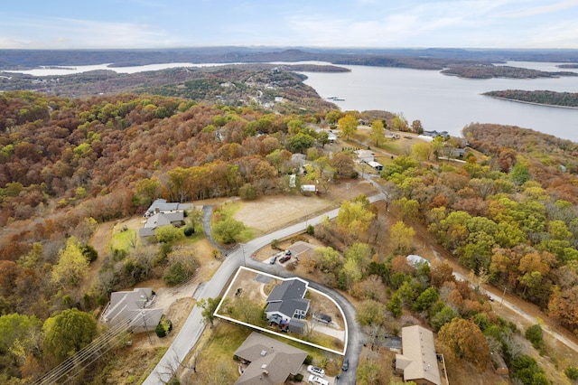 aerial view with a water view and a wooded view