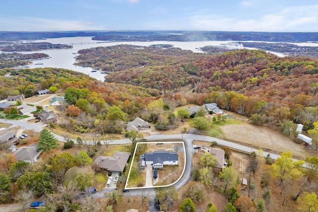 aerial view featuring a water view, a residential view, and a wooded view