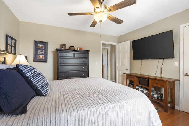 bedroom with ceiling fan and dark wood-style flooring