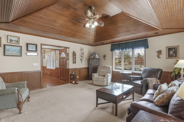 living room with carpet, a wainscoted wall, ceiling fan, wood walls, and wooden ceiling