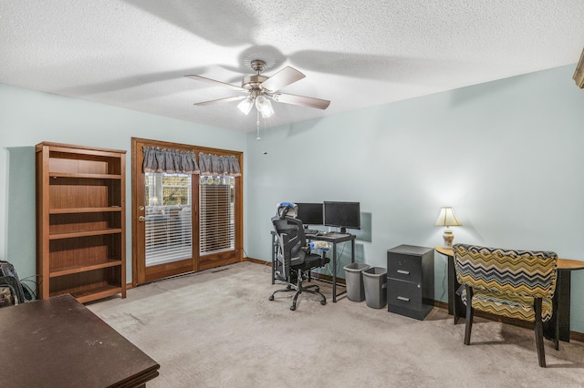 home office featuring baseboards, a textured ceiling, ceiling fan, and carpet floors