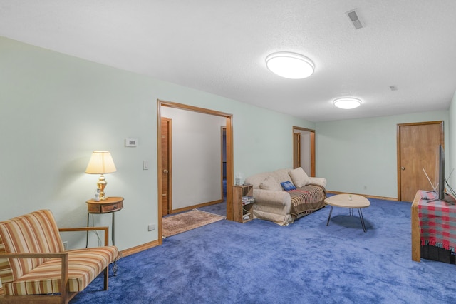 sitting room with visible vents, a textured ceiling, baseboards, and carpet