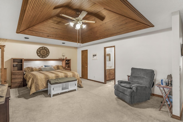 bedroom featuring a ceiling fan, baseboards, a tray ceiling, wooden ceiling, and carpet flooring