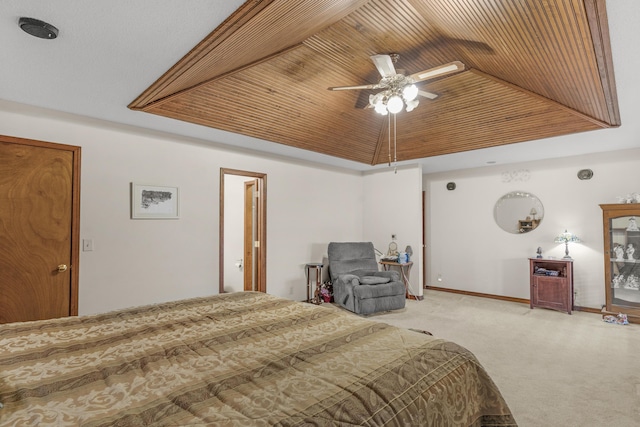 carpeted bedroom with a ceiling fan, baseboards, vaulted ceiling, wood ceiling, and a raised ceiling