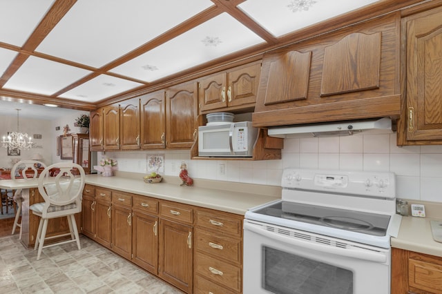 kitchen featuring white appliances, light countertops, brown cabinets, and backsplash