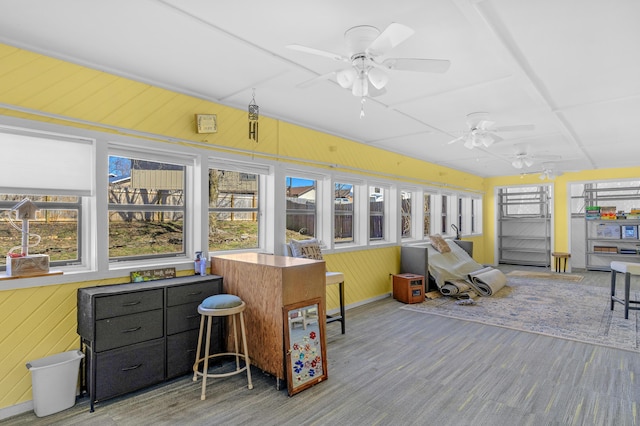 sunroom with a ceiling fan