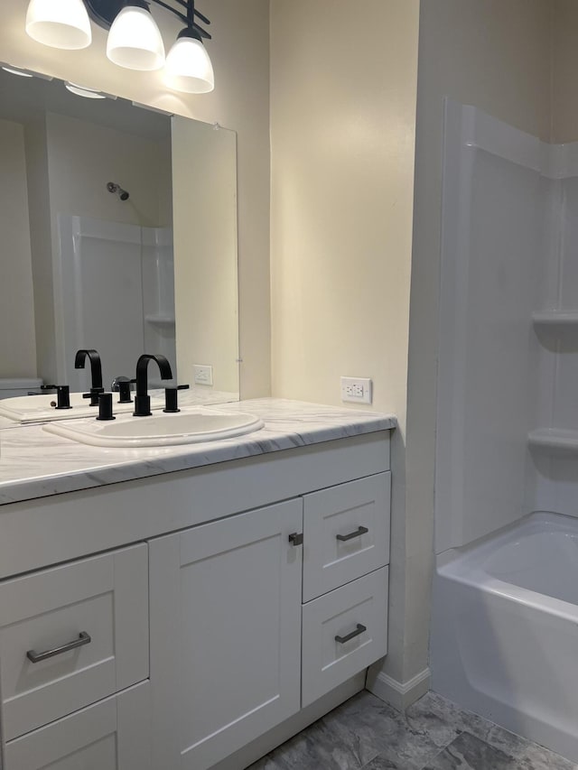 full bathroom with shower / washtub combination, marble finish floor, and vanity