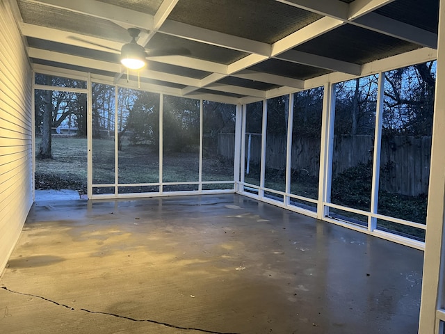 unfurnished sunroom with a ceiling fan