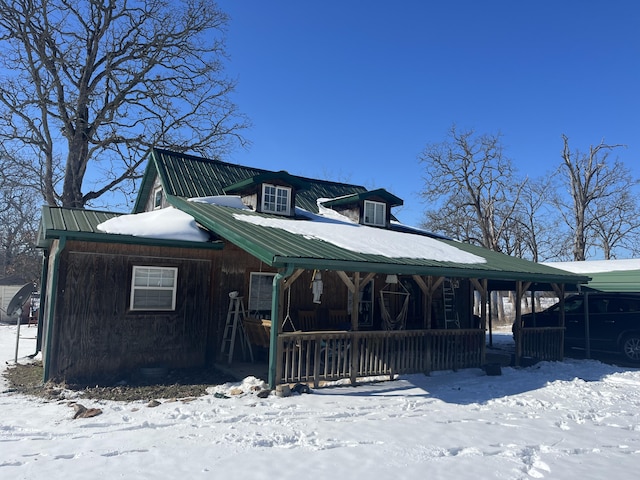 view of front of home with metal roof and a carport