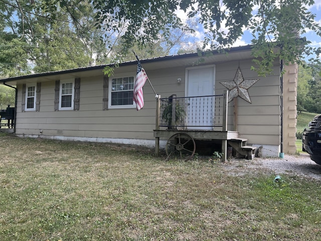 rear view of house featuring a lawn