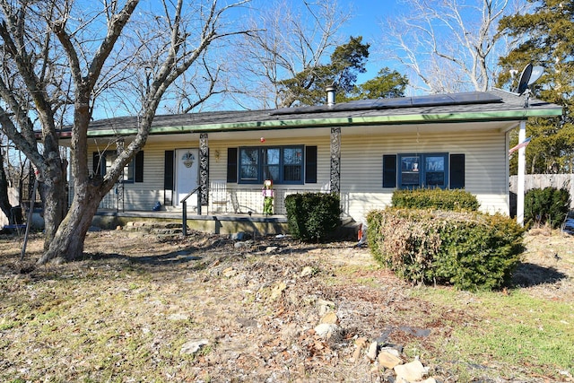 single story home with covered porch and solar panels