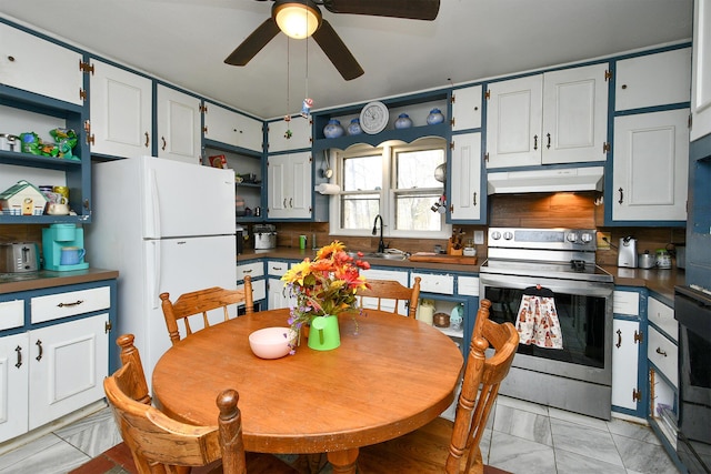 kitchen featuring electric range, dark countertops, freestanding refrigerator, under cabinet range hood, and open shelves