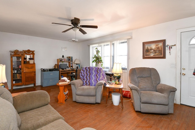 living room featuring a ceiling fan and wood finished floors