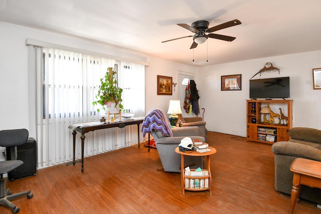 living area featuring wood finished floors and a ceiling fan