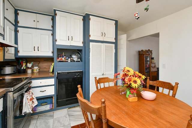 kitchen with wall oven, dark countertops, white cabinetry, and stainless steel electric range