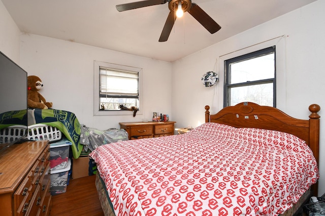 bedroom with dark wood-style floors and ceiling fan