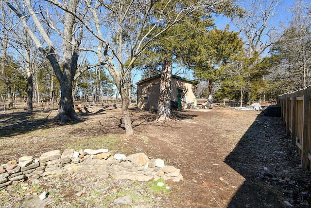 view of yard featuring fence and an outdoor structure