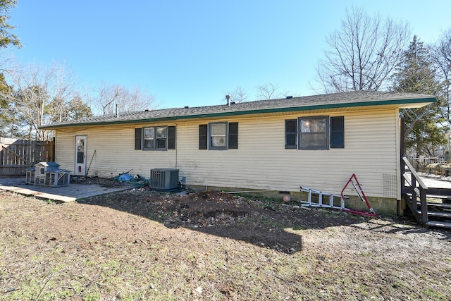 rear view of property featuring cooling unit and fence