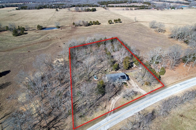 birds eye view of property with a rural view