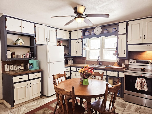 kitchen with freestanding refrigerator, open shelves, under cabinet range hood, and stainless steel electric stove