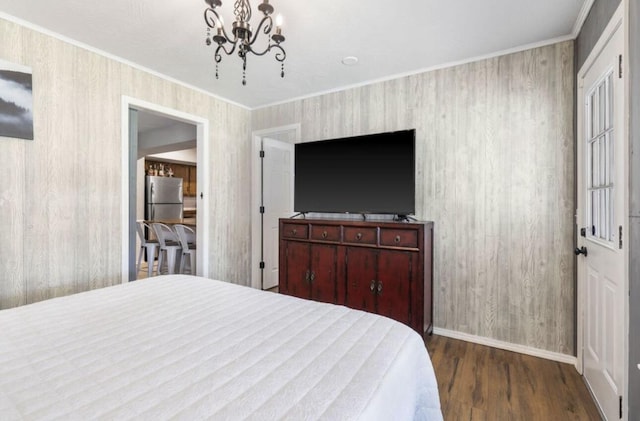 bedroom featuring ornamental molding, a chandelier, dark wood-style flooring, and freestanding refrigerator