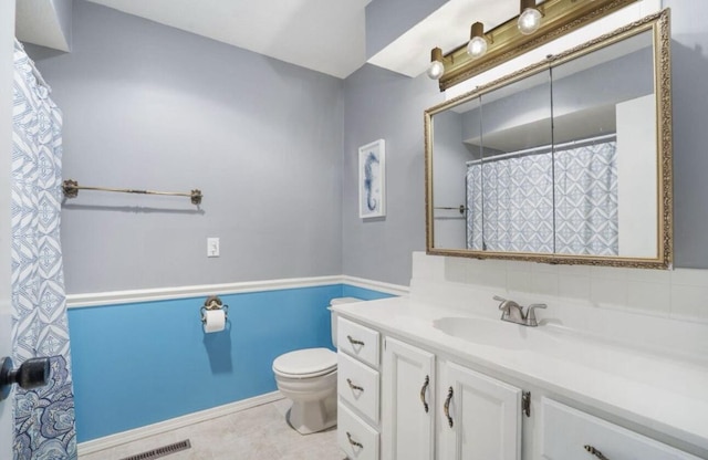 bathroom with visible vents, toilet, and vanity