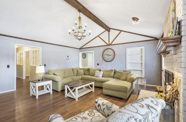 living room with vaulted ceiling with beams, a brick fireplace, ornamental molding, and dark wood-type flooring