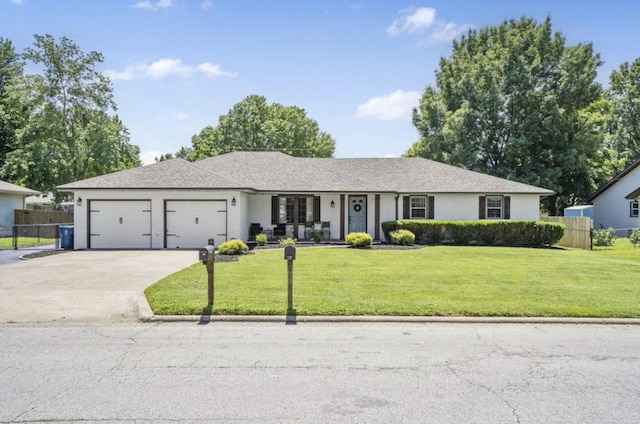 ranch-style house featuring a garage, a front yard, concrete driveway, and fence