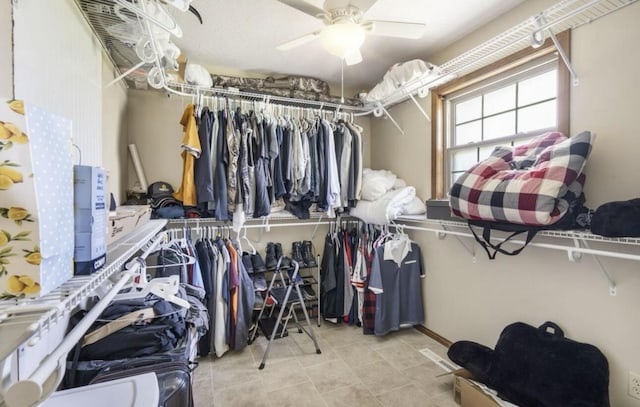 spacious closet with a ceiling fan