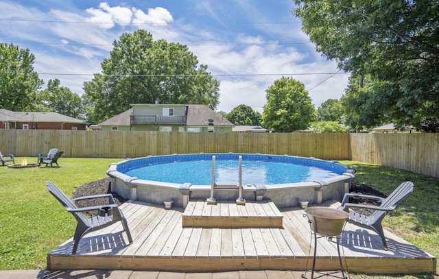 view of pool featuring a fenced in pool, a fenced backyard, a lawn, and a deck