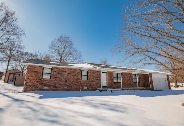 ranch-style home with a garage, brick siding, and crawl space