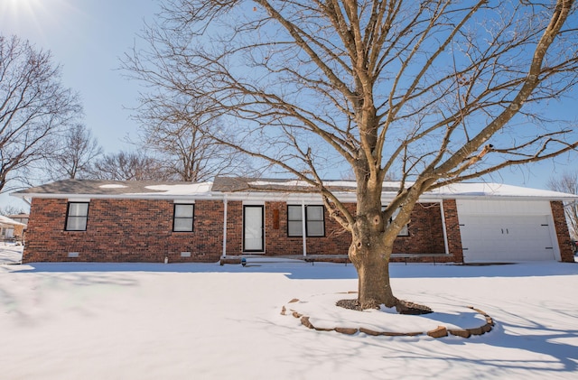 ranch-style house with crawl space, an attached garage, and brick siding