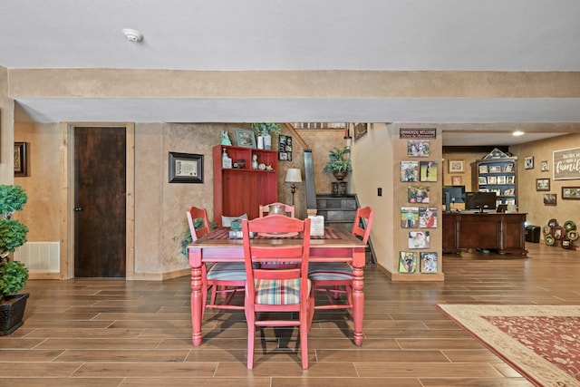 dining room featuring wood tiled floor, visible vents, and baseboards