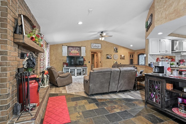 living room featuring recessed lighting, stone finish floor, vaulted ceiling, and ceiling fan