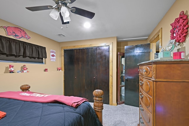 bedroom featuring a closet, carpet, visible vents, and a ceiling fan