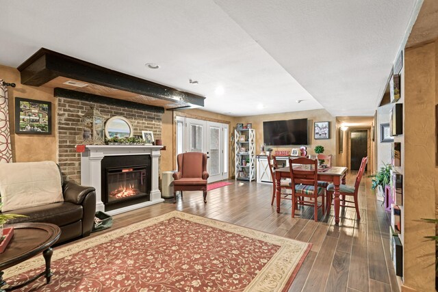 living room with wood finished floors and a glass covered fireplace