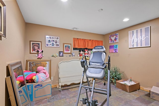 interior space featuring baseboards, visible vents, stone finish floor, and recessed lighting