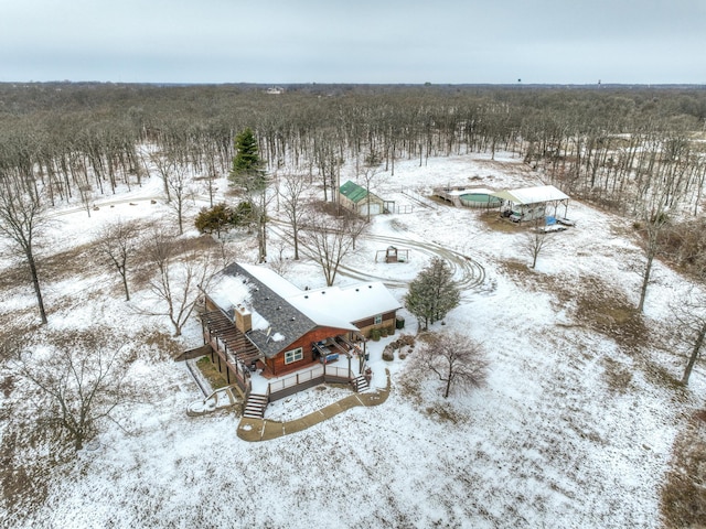 snowy aerial view with a forest view