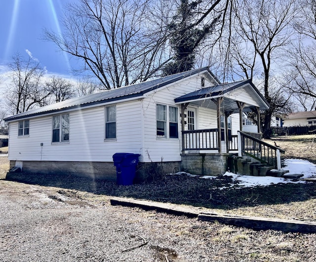 view of front of home with a porch and metal roof