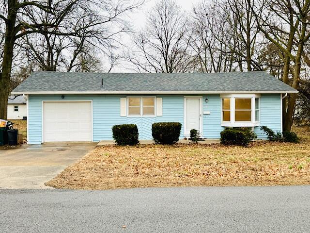 single story home with a garage and driveway