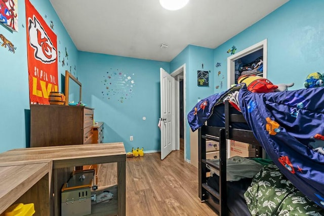 bedroom featuring baseboards and wood finished floors