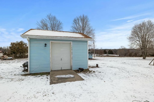 snow covered structure with an outdoor structure