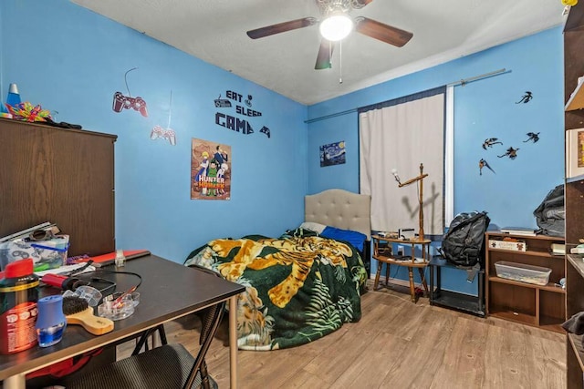 bedroom with light wood finished floors and ceiling fan