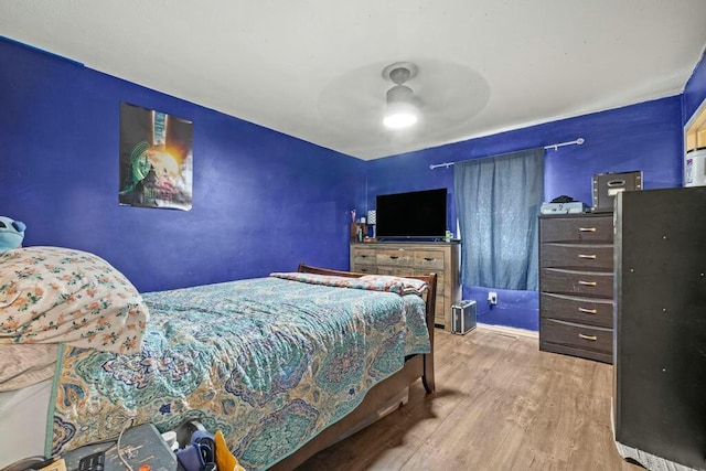 bedroom with ceiling fan and light wood finished floors