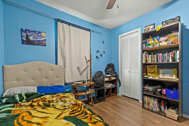 bedroom with a closet, a ceiling fan, and wood finished floors