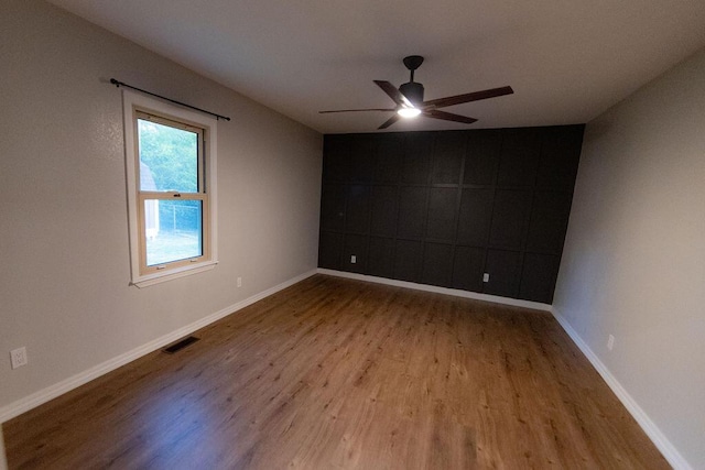 912 Armstrong Ave, West Plains, MO 65775 - empty room with wood finished floors, visible vents, a ceiling fan, and baseboards